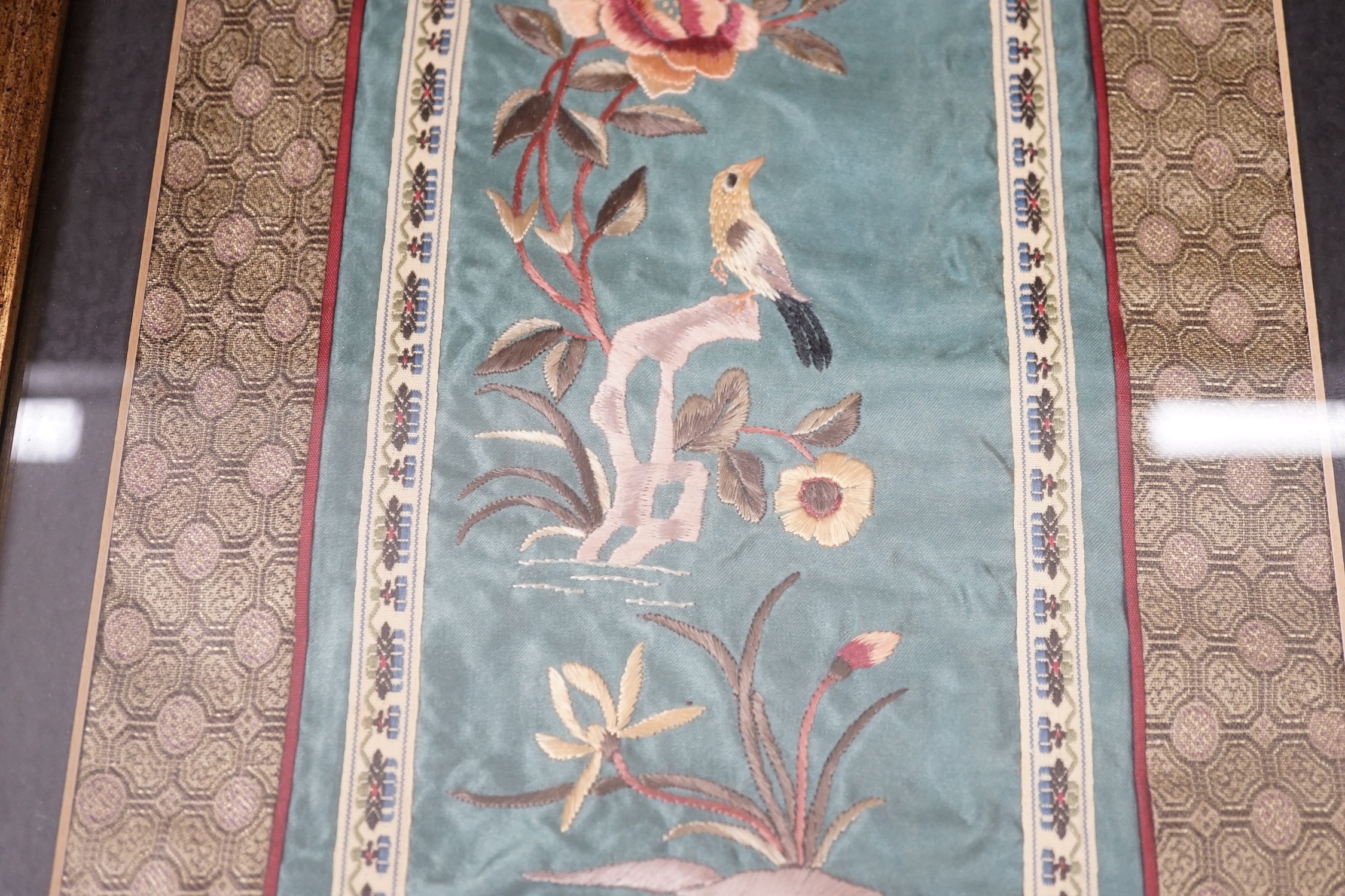 A pair of framed Chinese embroideries with bird and flower decoration, 34 x 14cm